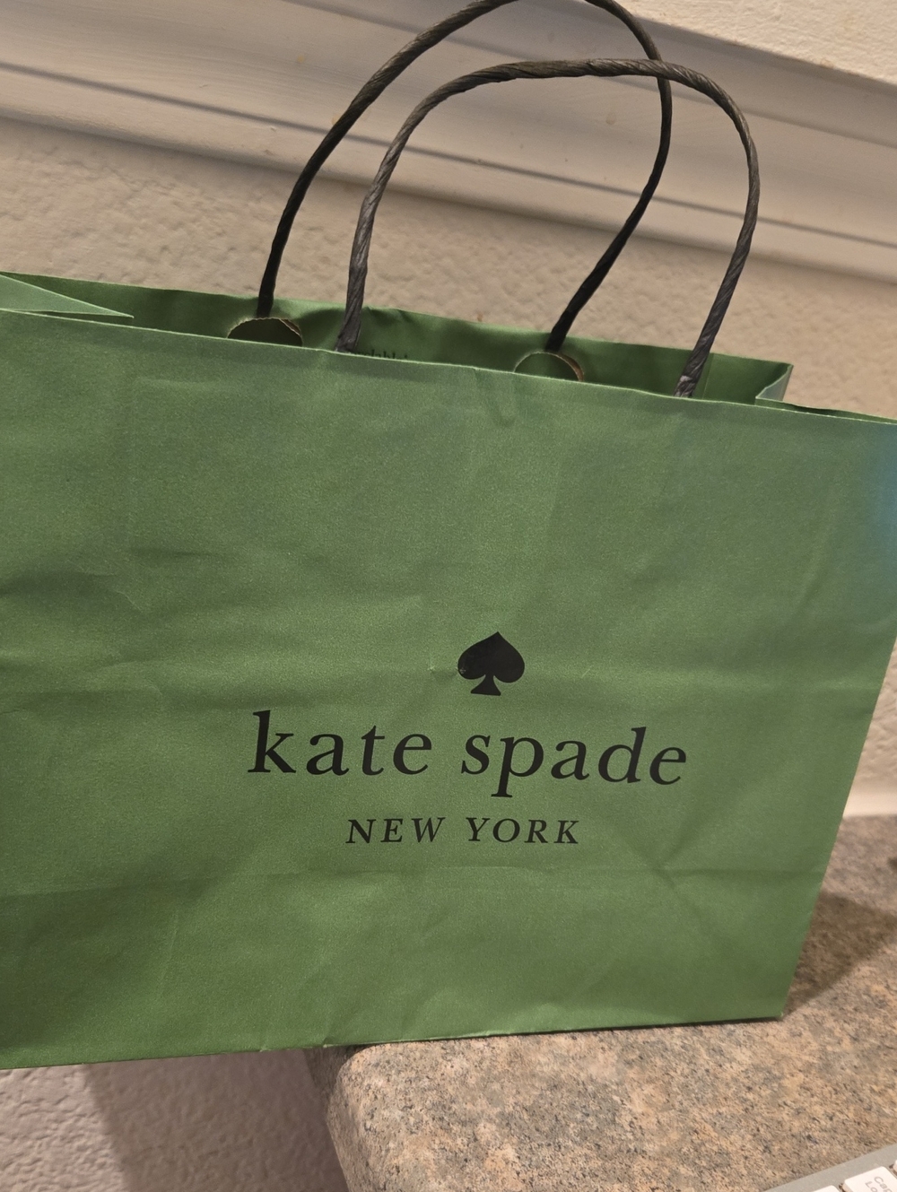 Kate Spade green tote with black logo and handles